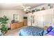 Well-lit bedroom features a ceiling fan, closet, wooden dresser, and neutral walls at 2608 Golfside Dr, Las Vegas, NV 89134