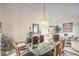 Chic dining room with modern chandelier, glass table, comfortable patterned chairs and bright natural light at 2608 Golfside Dr, Las Vegas, NV 89134