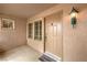 Inviting front entrance with covered porch, stylish front door, and exterior lighting at 2608 Golfside Dr, Las Vegas, NV 89134