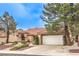 Charming single-story home featuring a desert landscaped front yard, mature trees, and a two-car garage at 2608 Golfside Dr, Las Vegas, NV 89134