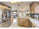 Bright kitchen with stainless steel fridge, light wood cabinets, and open view to living space at 2608 Golfside Dr, Las Vegas, NV 89134