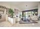 Spacious living room with tile floors, comfortable white seating, and a view of the backyard at 2608 Golfside Dr, Las Vegas, NV 89134