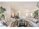Open-concept living room with white tile floors, plush sofas, and a bright, airy atmosphere at 2608 Golfside Dr, Las Vegas, NV 89134