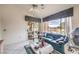 Spacious living room with a sliding door to the outside, and comfortable blue couches at 2608 Golfside Dr, Las Vegas, NV 89134