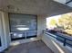 Balcony featuring an open view, metal railing, and natural light filtering through the window blinds at 2761 Lodestone Dr # 63, Las Vegas, NV 89117