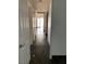 Bright hallway featuring neutral walls and dark-colored tile floors at 2761 Lodestone Dr # 63, Las Vegas, NV 89117