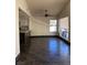 Open-plan living and kitchen space with wood-look tile and fan at 2761 Lodestone Dr # 63, Las Vegas, NV 89117