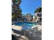 Community pool area featuring lounge chairs, tables and chairs and a well-maintained swimming pool at 2761 Lodestone Dr # 63, Las Vegas, NV 89117