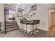 Stylish bar area with modern stools, granite countertop and seamless access to dining area at 2813 Via Avanti St, Henderson, NV 89074
