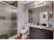 Modern bathroom featuring a granite countertop, glass-enclosed shower, and stylish fixtures at 2813 Via Avanti St, Henderson, NV 89074