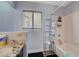 Well-lit bathroom featuring a bathtub with shower, granite countertop, and ample storage at 2813 Via Avanti St, Henderson, NV 89074