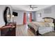 Comfortable bedroom features a traditional bed, dark wood furniture, and sliding glass doors at 2813 Via Avanti St, Henderson, NV 89074