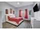 Comfortable bedroom with a queen bed, laminate floors, and abundant natural light at 2813 Via Avanti St, Henderson, NV 89074