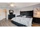 Primary bedroom featuring a statement black bedframe, contemporary decor, and wood-look floors at 2813 Via Avanti St, Henderson, NV 89074