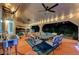 A covered patio features a dining area with a ceiling fan and string lights, perfect for outdoor relaxation at 2813 Via Avanti St, Henderson, NV 89074