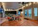 A covered patio features a dining area with a ceiling fan and string lights, perfect for outdoor relaxation at 2813 Via Avanti St, Henderson, NV 89074