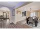 Bright dining room with wood floors and view of kitchen and additional dining space at 2813 Via Avanti St, Henderson, NV 89074