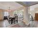 Charming dining room featuring wood floors, a modern light fixture, and large windows at 2813 Via Avanti St, Henderson, NV 89074