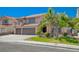 Charming two-story home with desert landscaping, three-car garage, and a tiled roof, during the day at 2813 Via Avanti St, Henderson, NV 89074