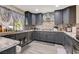 Modern kitchen features gray cabinets, stainless steel appliances, and granite countertops at 2813 Via Avanti St, Henderson, NV 89074
