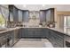 Stylish kitchen features gray cabinets, stainless steel appliances, and mosaic backsplash at 2813 Via Avanti St, Henderson, NV 89074