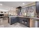 Contemporary kitchen with gray cabinets, granite counters, and stainless steel appliances at 2813 Via Avanti St, Henderson, NV 89074
