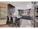 Modern kitchen with stainless steel appliances, granite countertops, and breakfast bar at 2813 Via Avanti St, Henderson, NV 89074