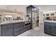 Open kitchen layout with gray cabinets, granite countertops, and stainless steel appliances at 2813 Via Avanti St, Henderson, NV 89074