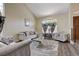 Elegant living room with high ceilings, arched windows, modern decor, and wood flooring at 2813 Via Avanti St, Henderson, NV 89074