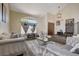 Elegant living room with high ceilings, arched windows, modern decor, and wood flooring at 2813 Via Avanti St, Henderson, NV 89074