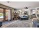 Comfortable living room with brick fireplace, French doors to the pool and open to the kitchen at 2813 Via Avanti St, Henderson, NV 89074
