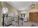 Elegant living room with high ceilings, arched windows, modern decor, and wood flooring at 2813 Via Avanti St, Henderson, NV 89074