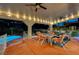 Covered patio with string lights, seating area, and a pool at 2813 Via Avanti St, Henderson, NV 89074