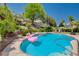 Refreshing pool with landscaped surroundings and a pink flamingo float, perfect for relaxation at 2813 Via Avanti St, Henderson, NV 89074