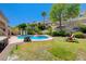 Inviting pool and backyard with lush landscaping, mature trees, and an idyllic retreat for relaxing and entertaining at 2813 Via Avanti St, Henderson, NV 89074