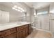 Stylish bathroom featuring a large vanity, shower, and tile flooring at 3330 Unicorn Ave, Pahrump, NV 89048
