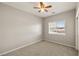 Neutrally painted bedroom with a ceiling fan and a window at 3330 Unicorn Ave, Pahrump, NV 89048