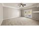Spacious bedroom featuring neutral paint, a ceiling fan, and French doors to the backyard at 3330 Unicorn Ave, Pahrump, NV 89048
