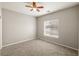 Clean bedroom with neutral carpet, ceiling fan, and a window providing natural light at 3330 Unicorn Ave, Pahrump, NV 89048