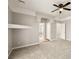 Neutral bedroom featuring a decorative ledge, ceiling fan, and access to bathroom and hallway at 3330 Unicorn Ave, Pahrump, NV 89048