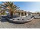 Beautiful house featuring landscaped backyard, covered patio, and stone accents at 3330 Unicorn Ave, Pahrump, NV 89048