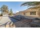Exterior view of home, backyard, and surrounding landscape featuring mature trees at 3330 Unicorn Ave, Pahrump, NV 89048