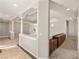 Open hallway with decorative columns, neutral paint, and access to carpeted area at 3330 Unicorn Ave, Pahrump, NV 89048