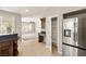 Open kitchen layout with view to the Gathering room, stainless refrigerator, and walk-in pantry at 3330 Unicorn Ave, Pahrump, NV 89048