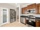 Modern kitchen with stainless steel appliances, beautiful wood cabinetry, and a stainless refrigerator at 3330 Unicorn Ave, Pahrump, NV 89048
