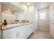 Elegant bathroom with double sinks, granite countertops, and a glass-enclosed shower at 3747 Lambent Ave, North Las Vegas, NV 89084