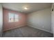 Cozy bedroom with neutral carpet, large window, and closet space at 3747 Lambent Ave, North Las Vegas, NV 89084