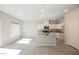 Stylish kitchen boasts granite countertops, white cabinets and an island with seating at 3747 Lambent Ave, North Las Vegas, NV 89084