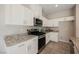 Modern kitchen features granite countertops, sleek white cabinets, and stainless appliances at 3747 Lambent Ave, North Las Vegas, NV 89084
