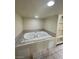 Bathroom with a built-in spa tub, decorative tile accents and recessed lighting at 3797 Monument St, Las Vegas, NV 89121